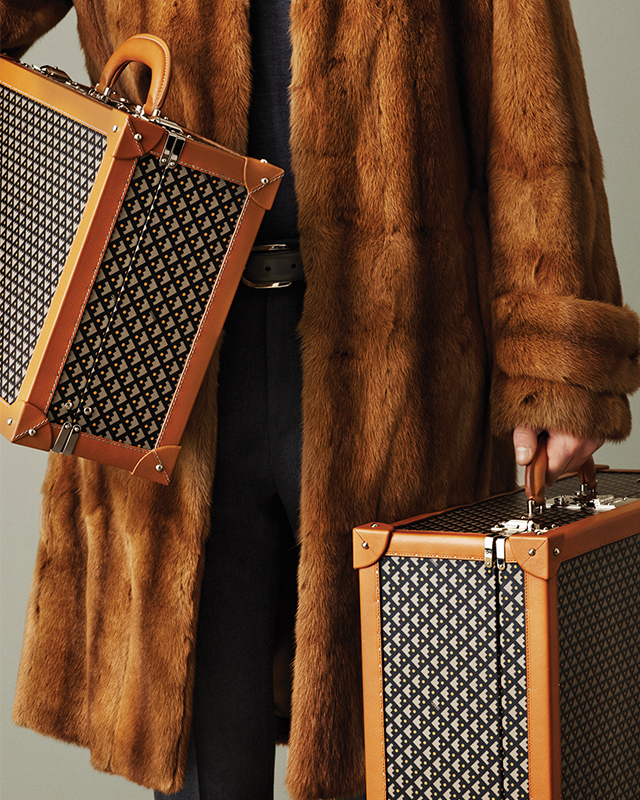 A fur coat and gorgeous luggage by Bally is the ultimate way to travel