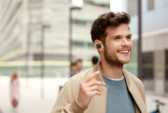 Man outdoors with Sony WF-1000MX3 headphones